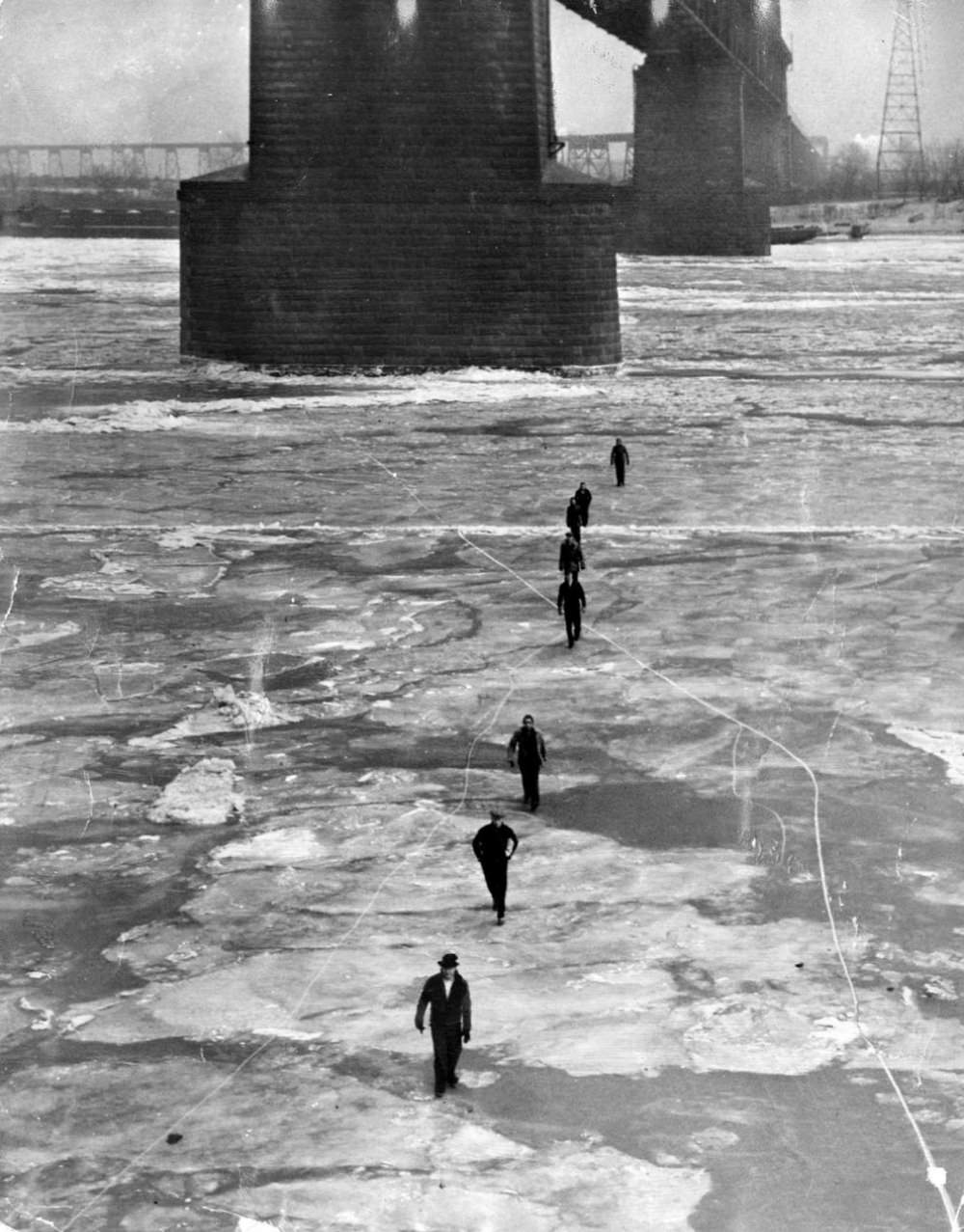 People walking across the frozen Mississippi River from East St. Louis to St. Louis on Feb. 12, 1936.
