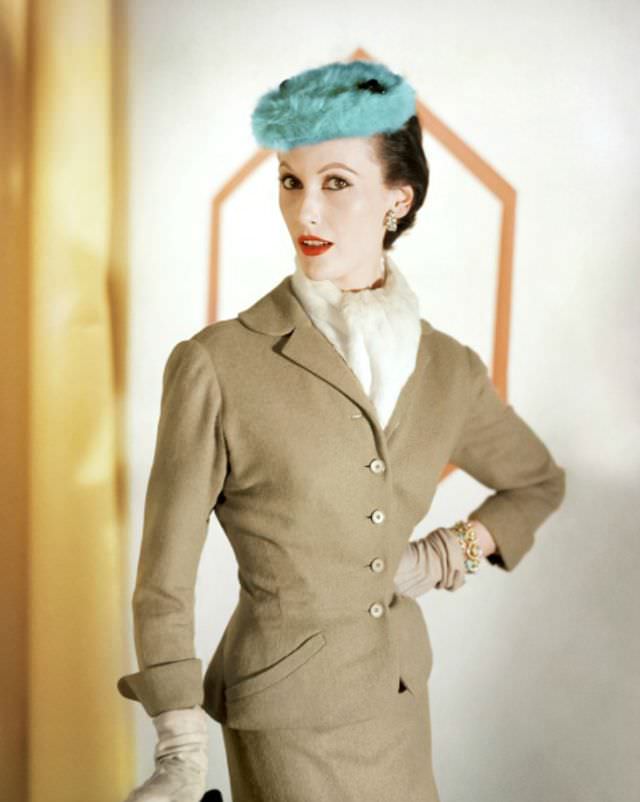 Mary Jane Russell in a camel wool suit by Mollie Parnis and a fur turquoise hat by Emme, 1953