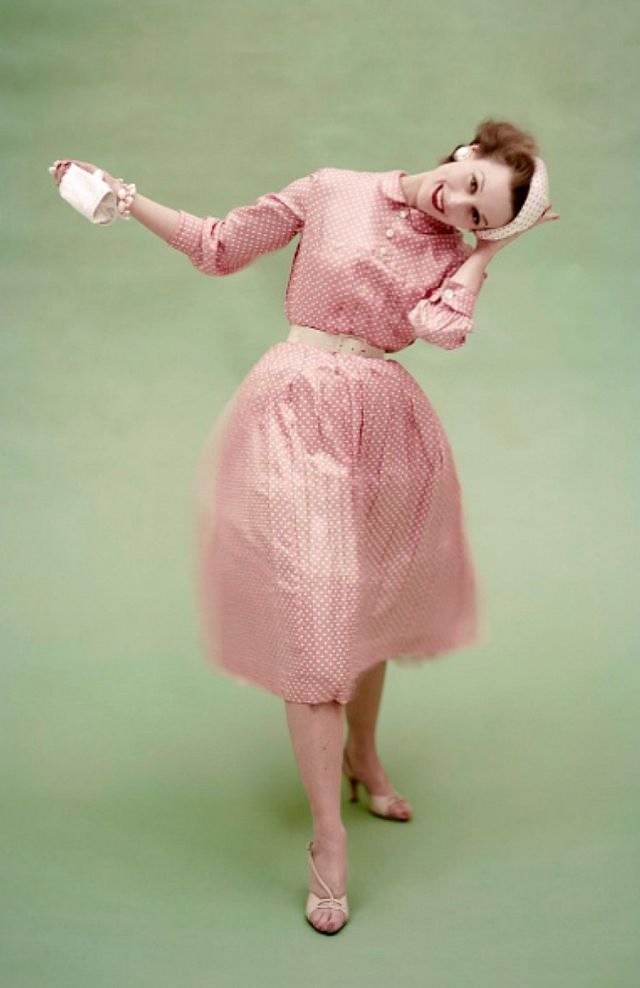 Model in a pink with white polka dot silk surah dress by Mollie Parnis and reverse dot beret, Vogue, March 1, 1955