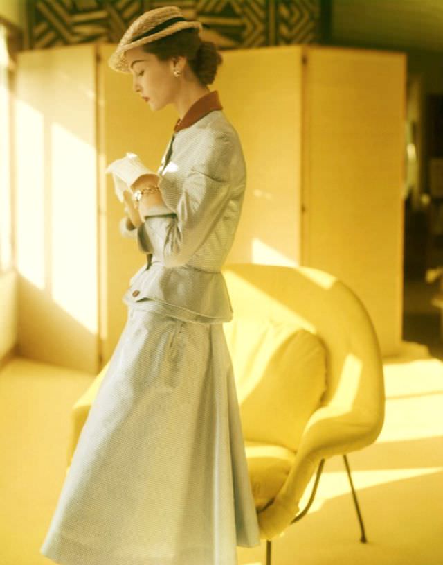 Eva Gerney wearing a suit of silk taffeta with peplum and velvet collar by Mollie Parnis, photo by Horst P. Horst, February 1951