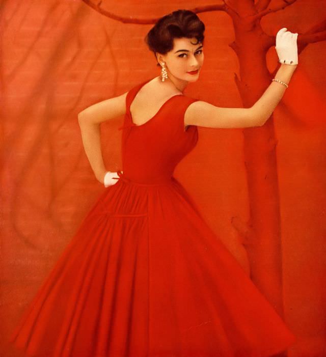 Anne Gunning in vibrant red Pima cotton voile dress by Mollie Parnis, Harper's Bazaar, May 1957