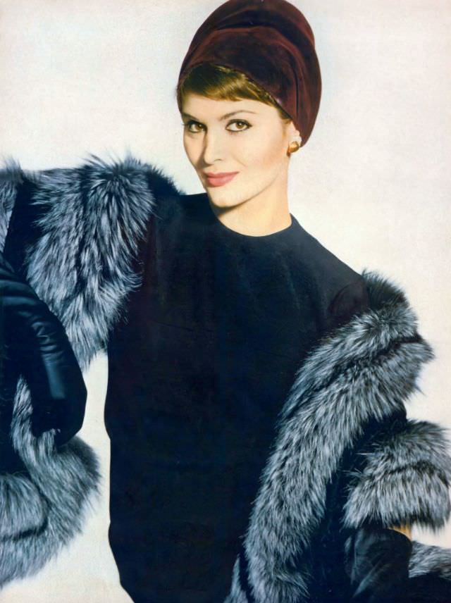 Isabella Albonico in black worsted jersey dress by Mollie Parnis, a raisin-colored velours hat by Sally Victor, and stole of black-dyed Russian broadtail lamb and Canadian fox by Fredrica, September 15, 1958