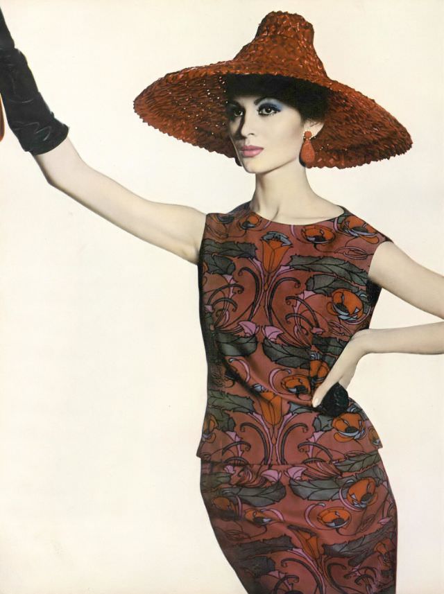 Isabella Albonico in boldly colored plum-red and blue print two-piece dress on Liberty of London silk by Mollie Parnis, red straw pagoda hat by Sally Victor, earrings by Hattie Carnegie, April 1, 1961