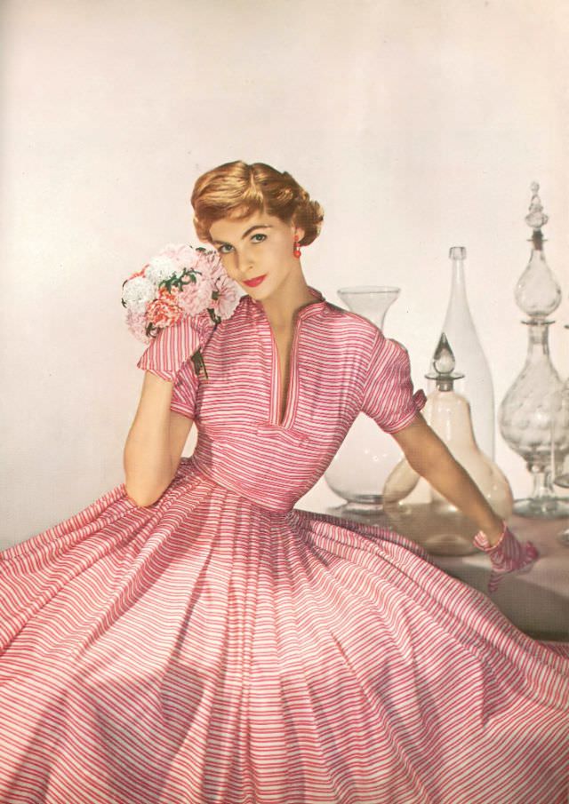 Georgia Hamilton in dress of white and pink striped silk by Mollie Parnis, Harper's Bazaar, April 1952