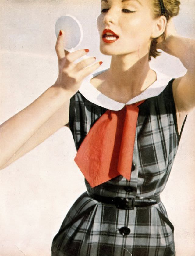 Cherry Nelms in black and gray plaid cotton dress with white piqué collar and black patent leather belt by Mollie Parnis, Bermuda, Harper's Bazaar, May 1953