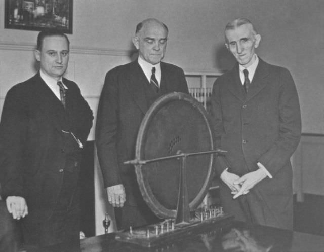 John T. Morris, Victor Beam and Tesla pose with the alternator that had been discovered.