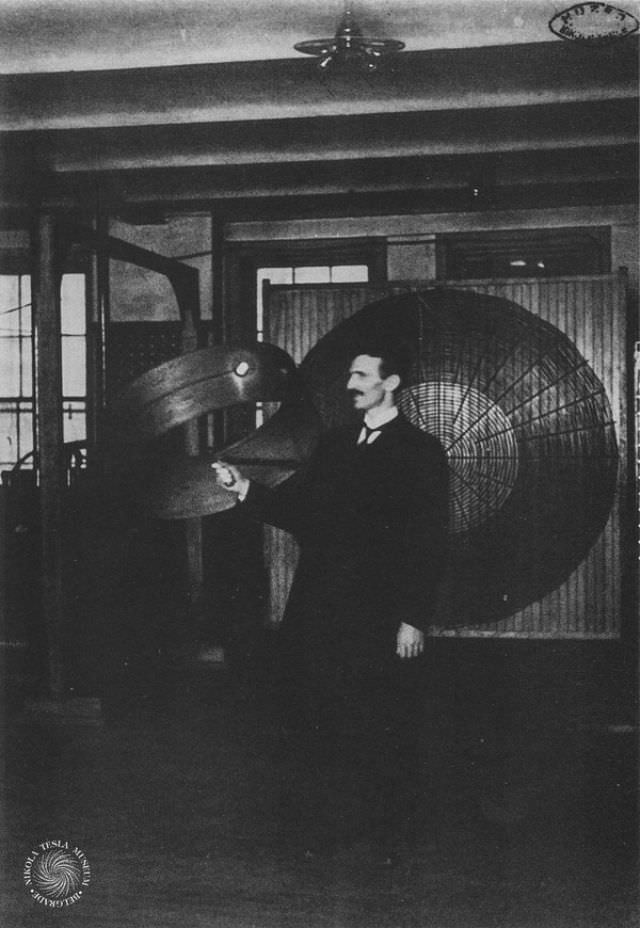 Tesla demonstrates “wireless” power transmission in his Houston Street laboratory in March 1899.