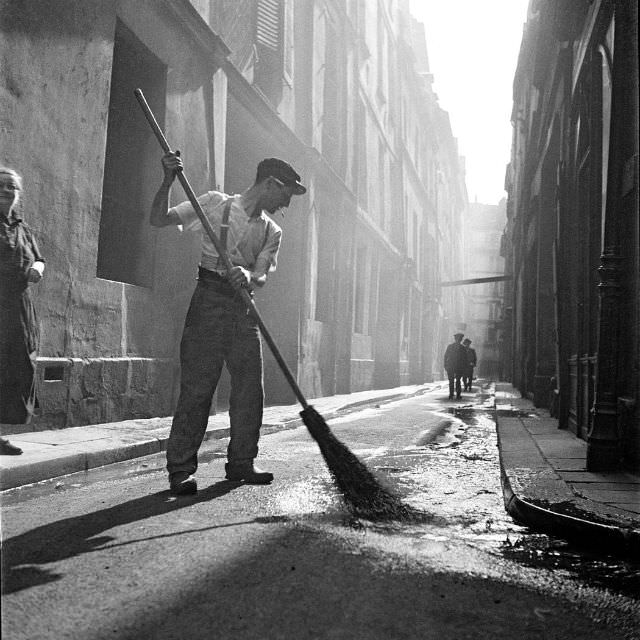 Street sweeper on rue Visconti, Paris, 1935.