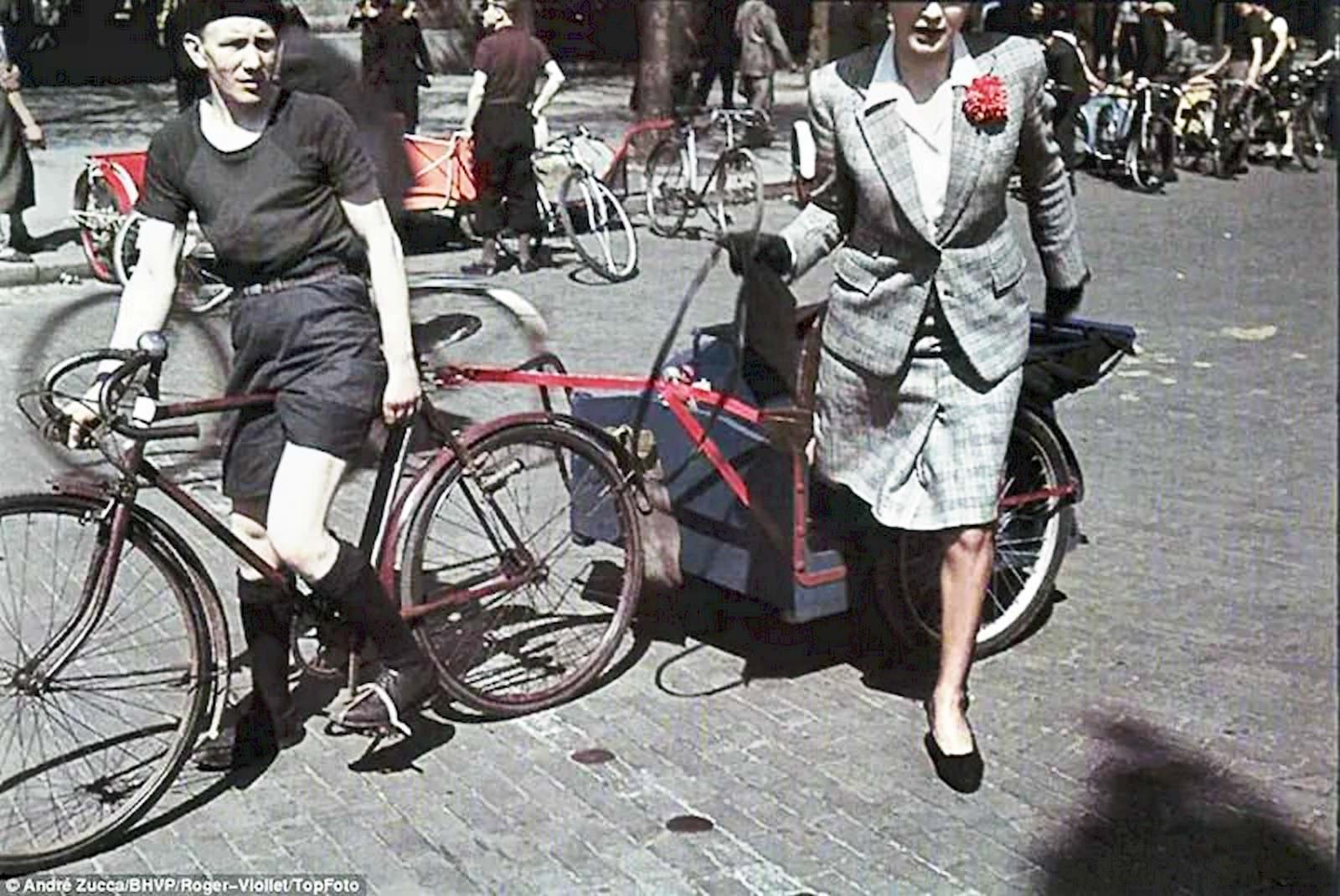 A smartly dressed woman steps from a bicycle taxi.
