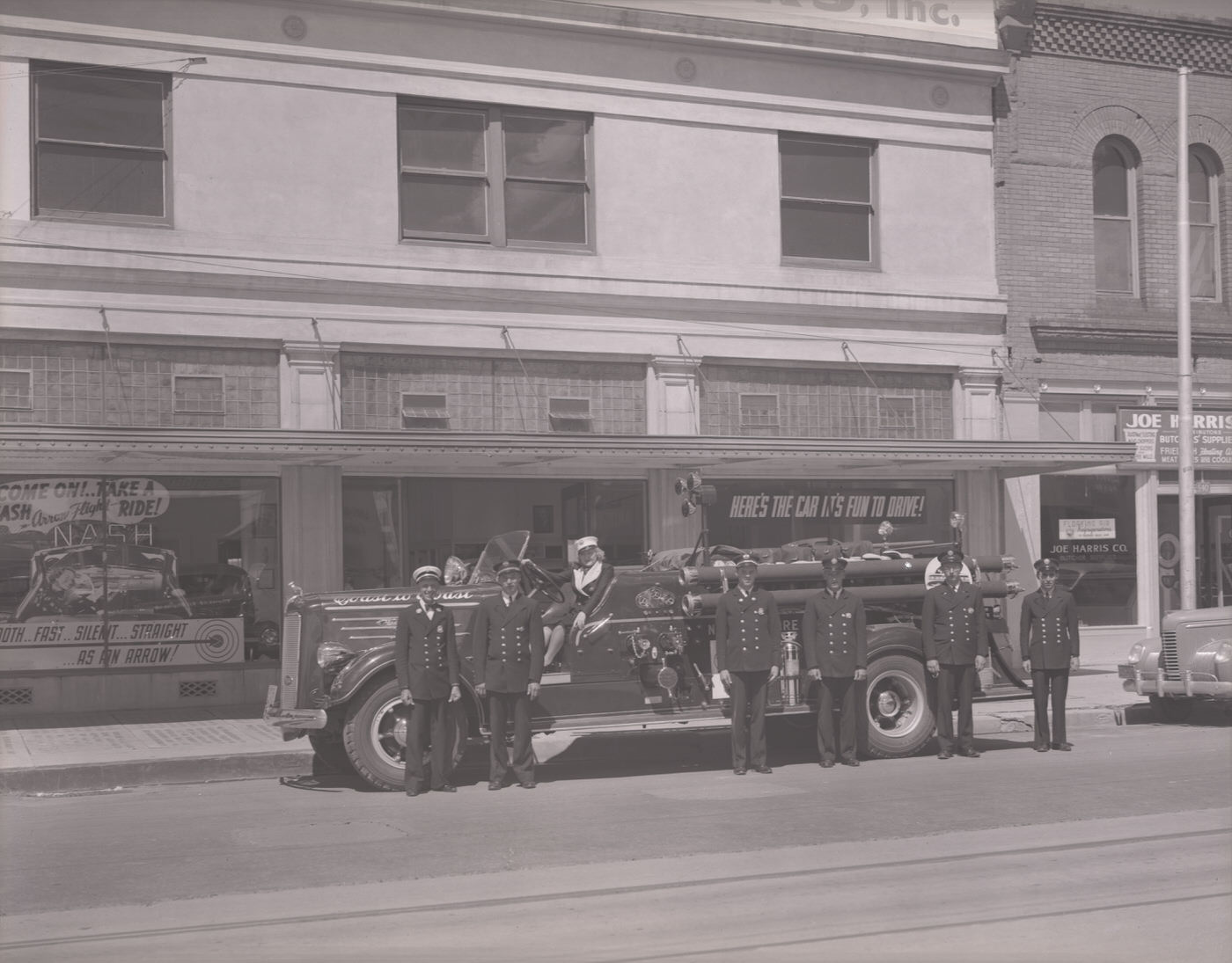 Fire Truck and Firemen in Front of Miller Brothers Motors, 1930s