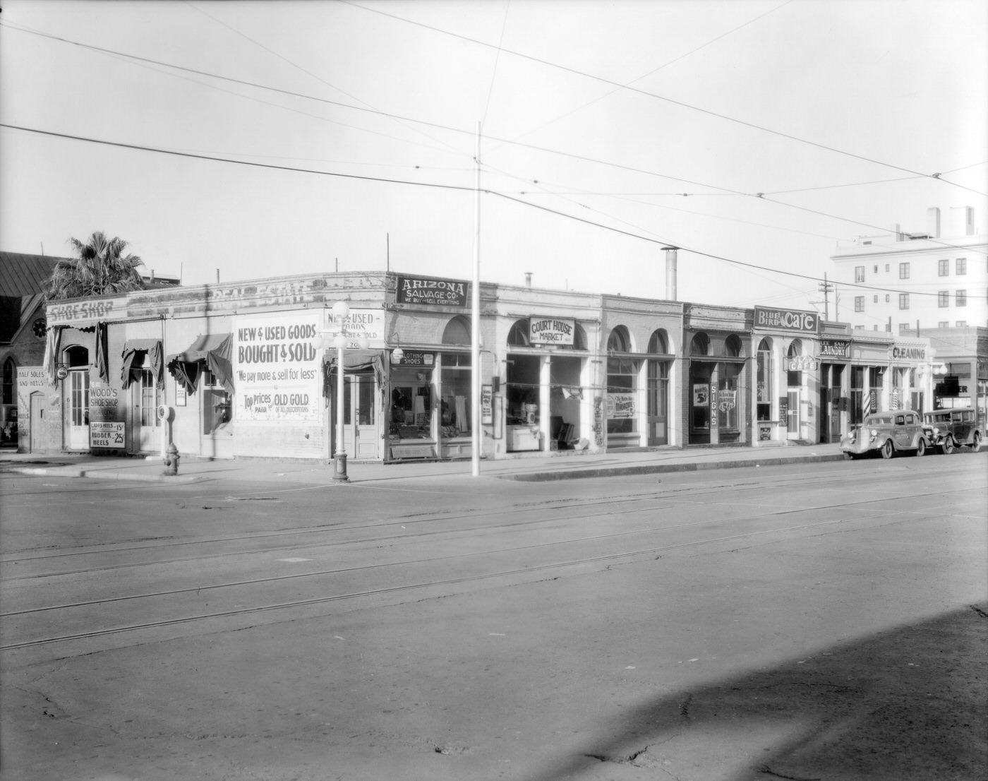 Southwest Corner of Second Ave. and Washington St., 1930s. Arizona Salvage Co., the Court House Market, the Blue Bird Café, and Wood's Shoe Shop are visible.