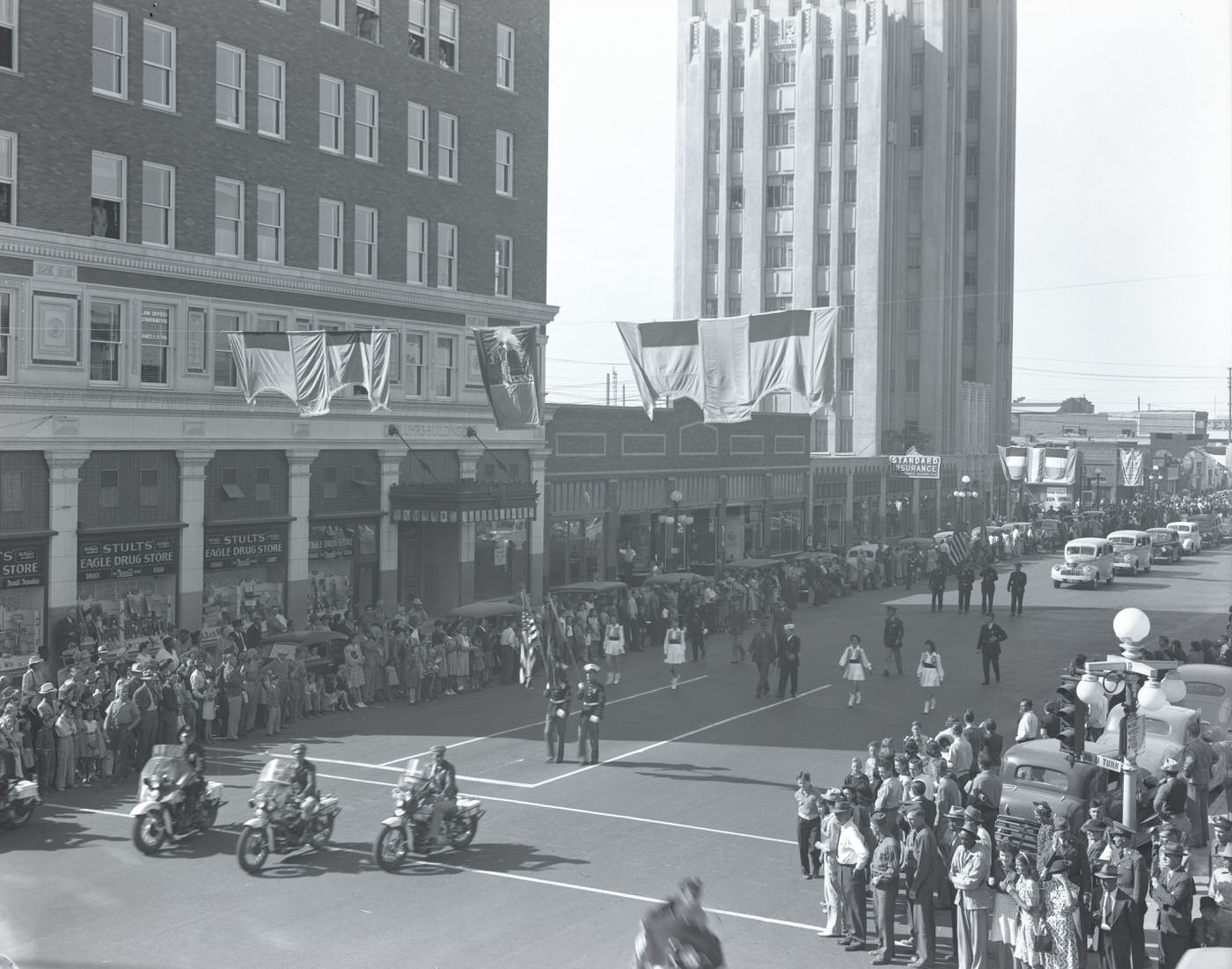 Parade in Phoenix. This parade is moving south past Stults' Eagle Drug Store located at 102-106 S. Central in Phoenix. The Luhrs Tower is visible in the background, 1941