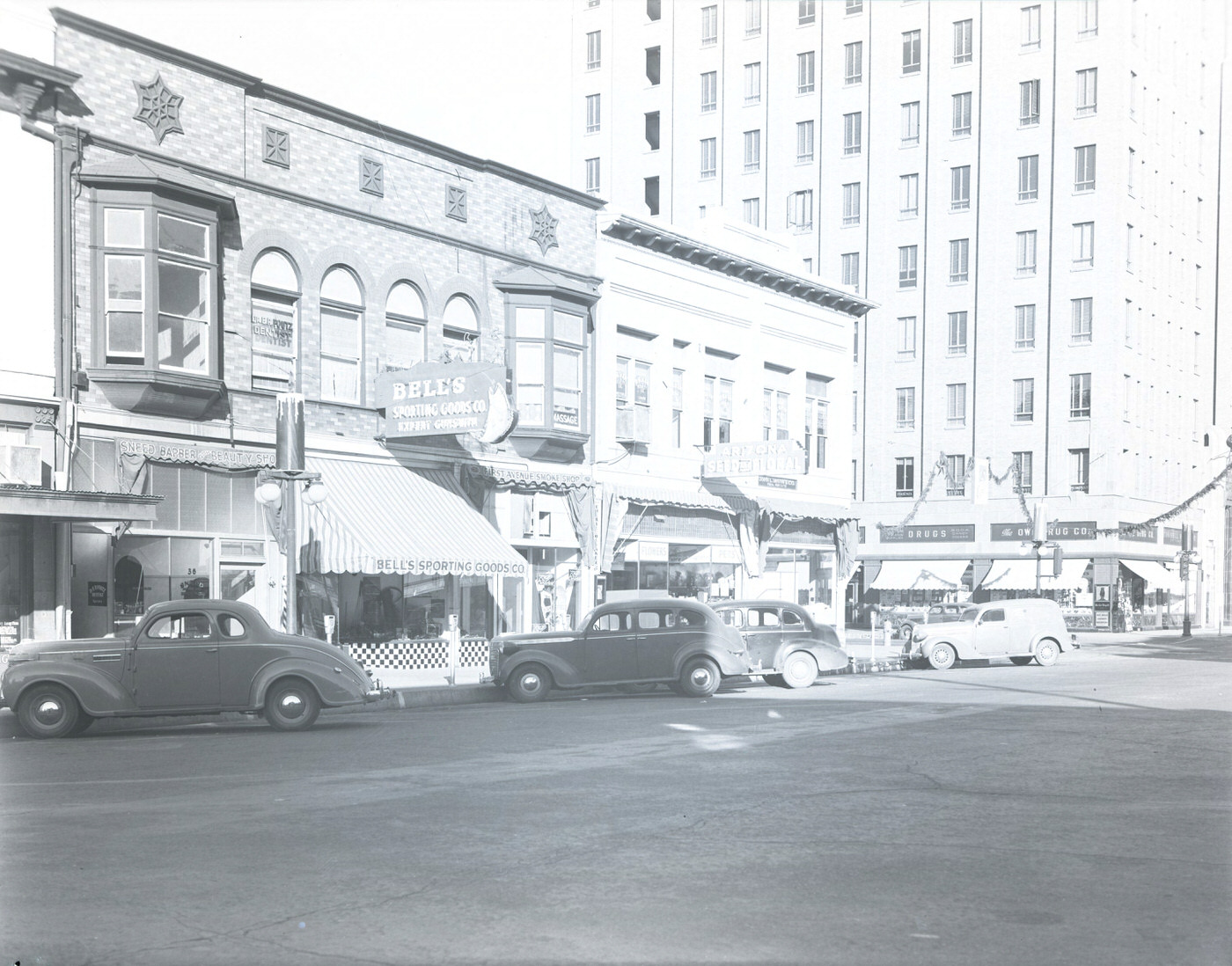 N. 1st Avenue. Depicts the 40 block of N. 1st Ave. Visible are Bell's Sporting Goods (40 N. 1st) and New Arizona Seed & Floral Co. (46 N. 1st), 1941