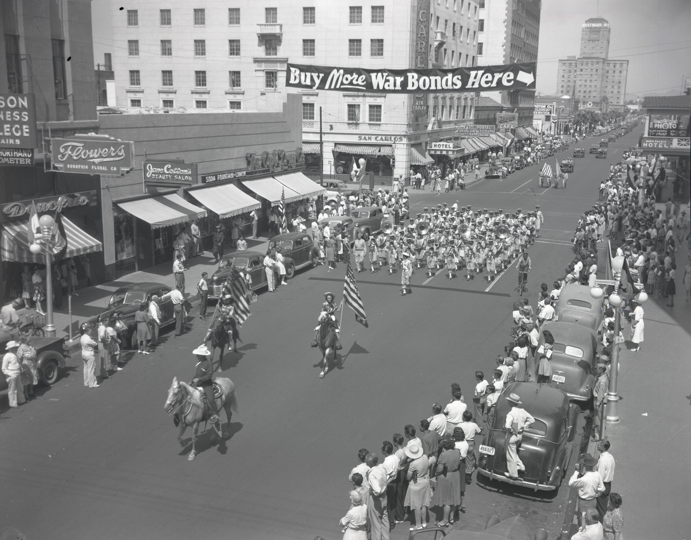 War Bonds Parade. The parade is moving south on Central Ave. at the intersection of Central Ave. and W. Monroe Street, 1943