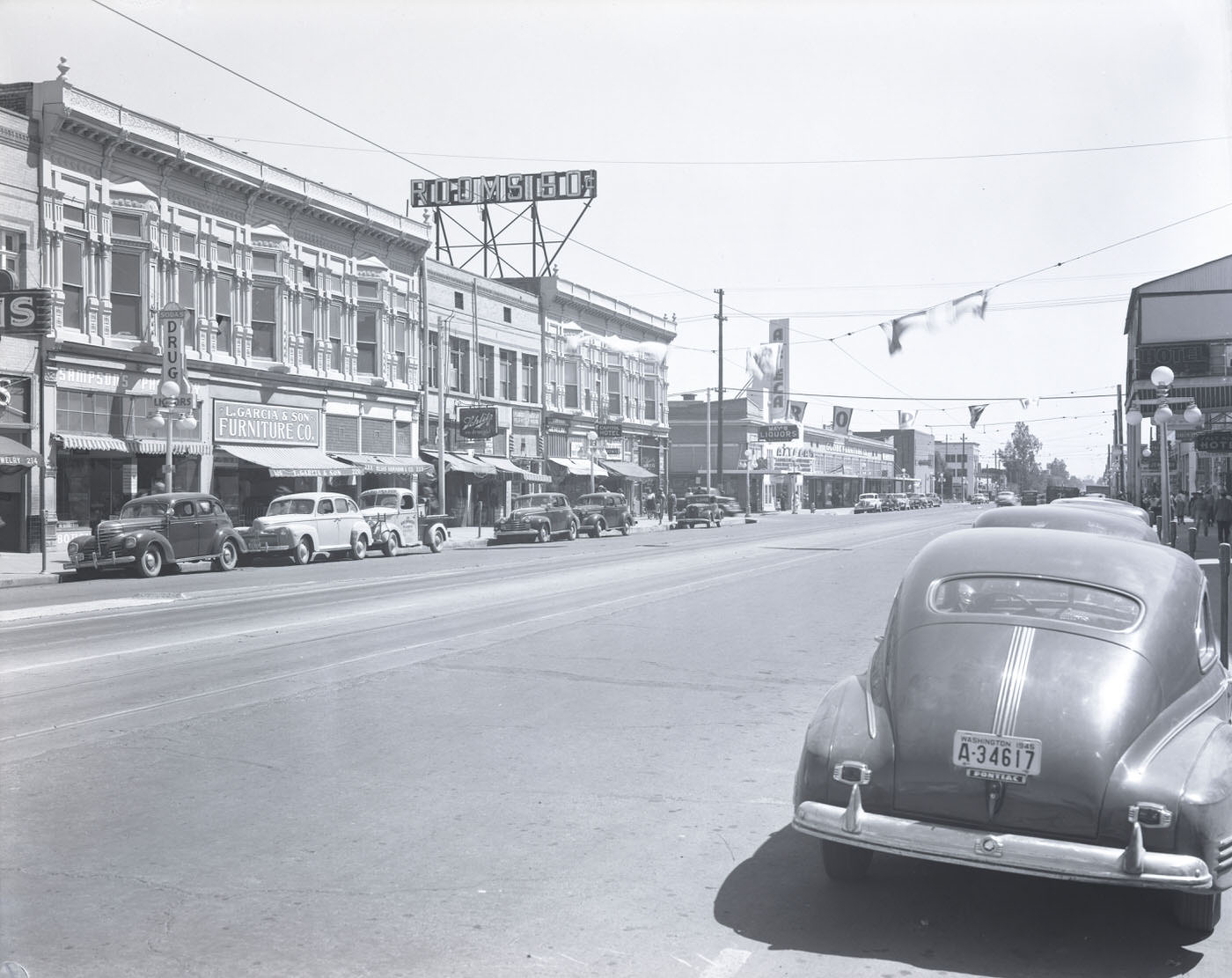 200 Block of E. Washington St., 1945. View looking toward the north side of E. Washington St. at the 200 block. Visible is L. Garcia & Son Furniture Co. (220 E. Washington).