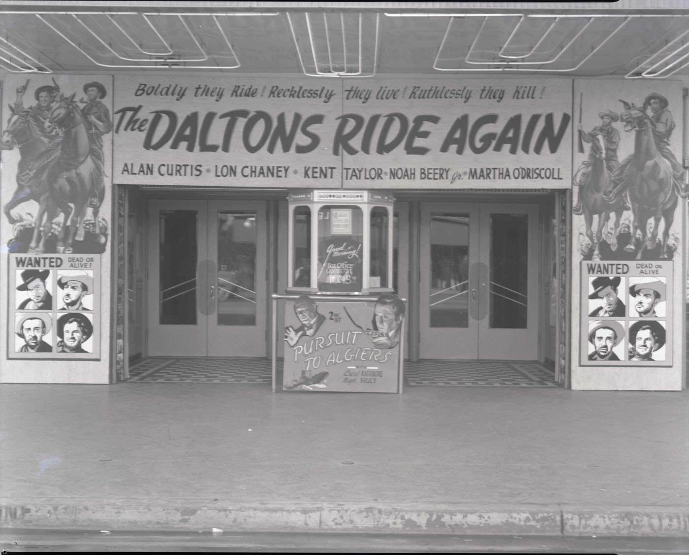 Rialto Theatre Exterior, 1946. Promotional material for "The Daltons Ride Again" is on display.
