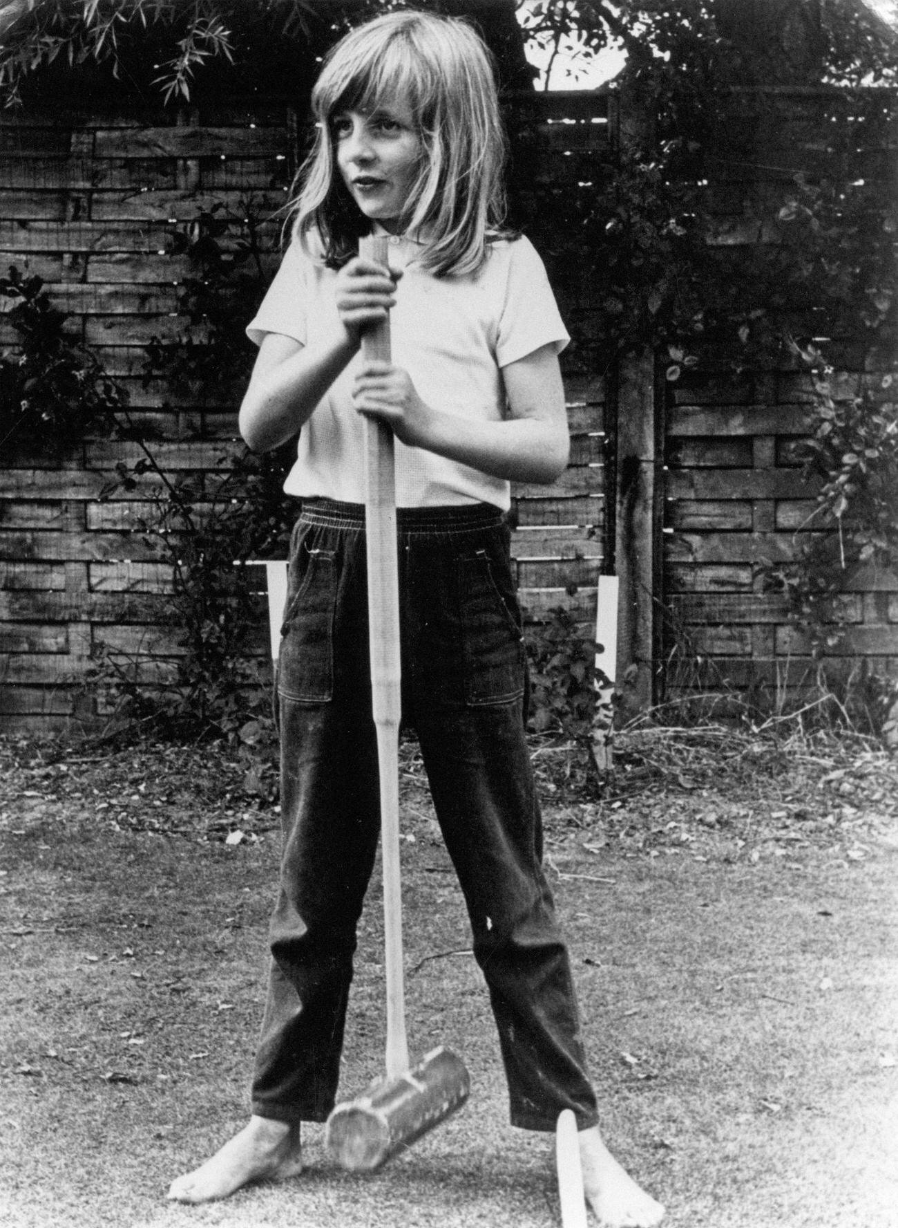 Lady Diana Spencer poses barefoot with a croquet mallet whilst on holiday in 1970 at Itchenor Sussex.