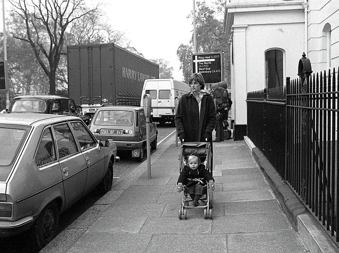 Lady Diana Spencer takes her young charge Patrick Robinson for his daily outing in the Eaton Square district of London during her time as a nanny, November 1980.