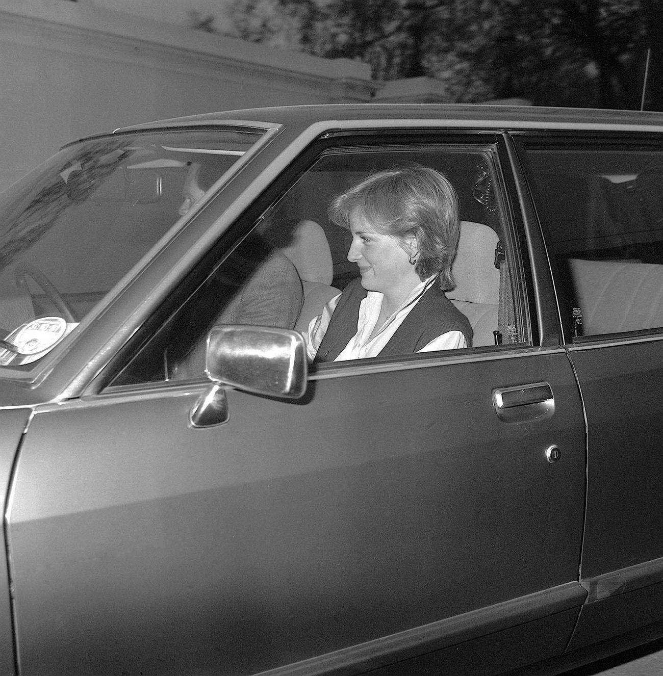 A smiling Lady diana Spencer, the 19-year old fiancee of Prince Charles being driven into her temporary new home after a visit to Buckingham Palace.