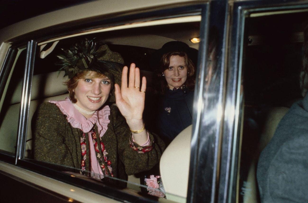 Princess Diana with her lady-in-waiting Lavinia Baring waves from the back seat of a car during her visit to her hometown in Northampton, England, 1981.