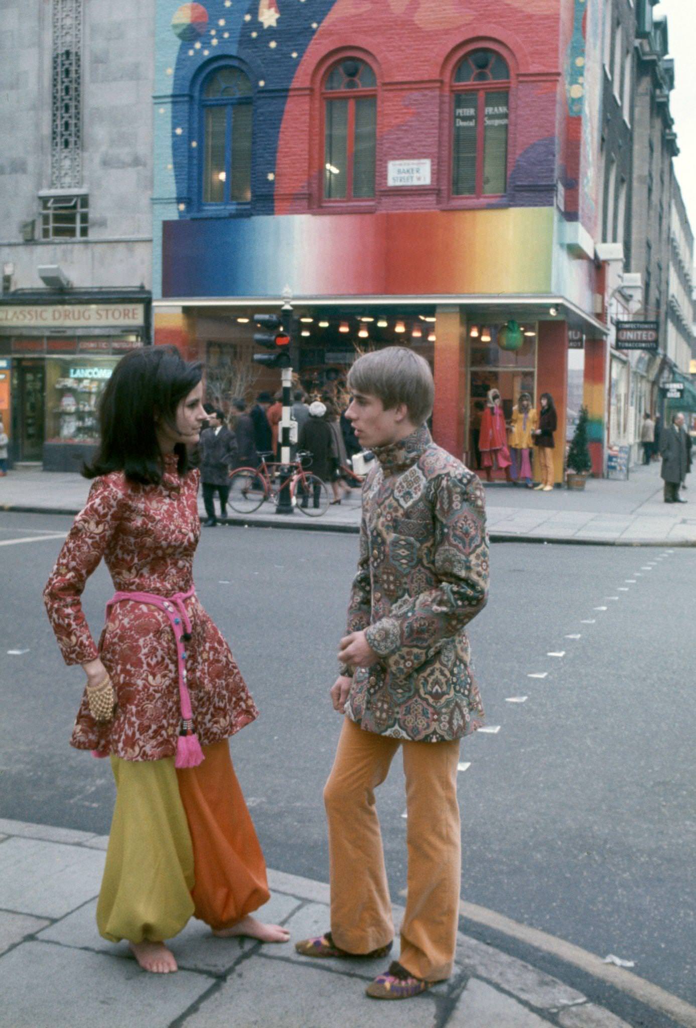 Two hippies standing outside the Apple Boutique, a retail store founded by The Beatles as part of their Apple Corps business venture, London, 1967