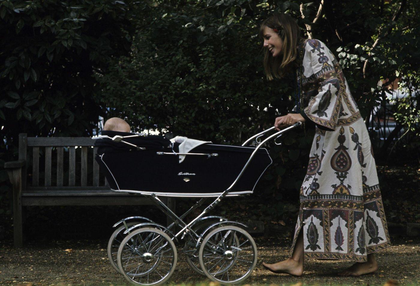 Jane Birkin and John Crittle dressed in hippie fashion. Jane wearing a cashmere dress and necklace, pushing her daughter Kate, in a pram