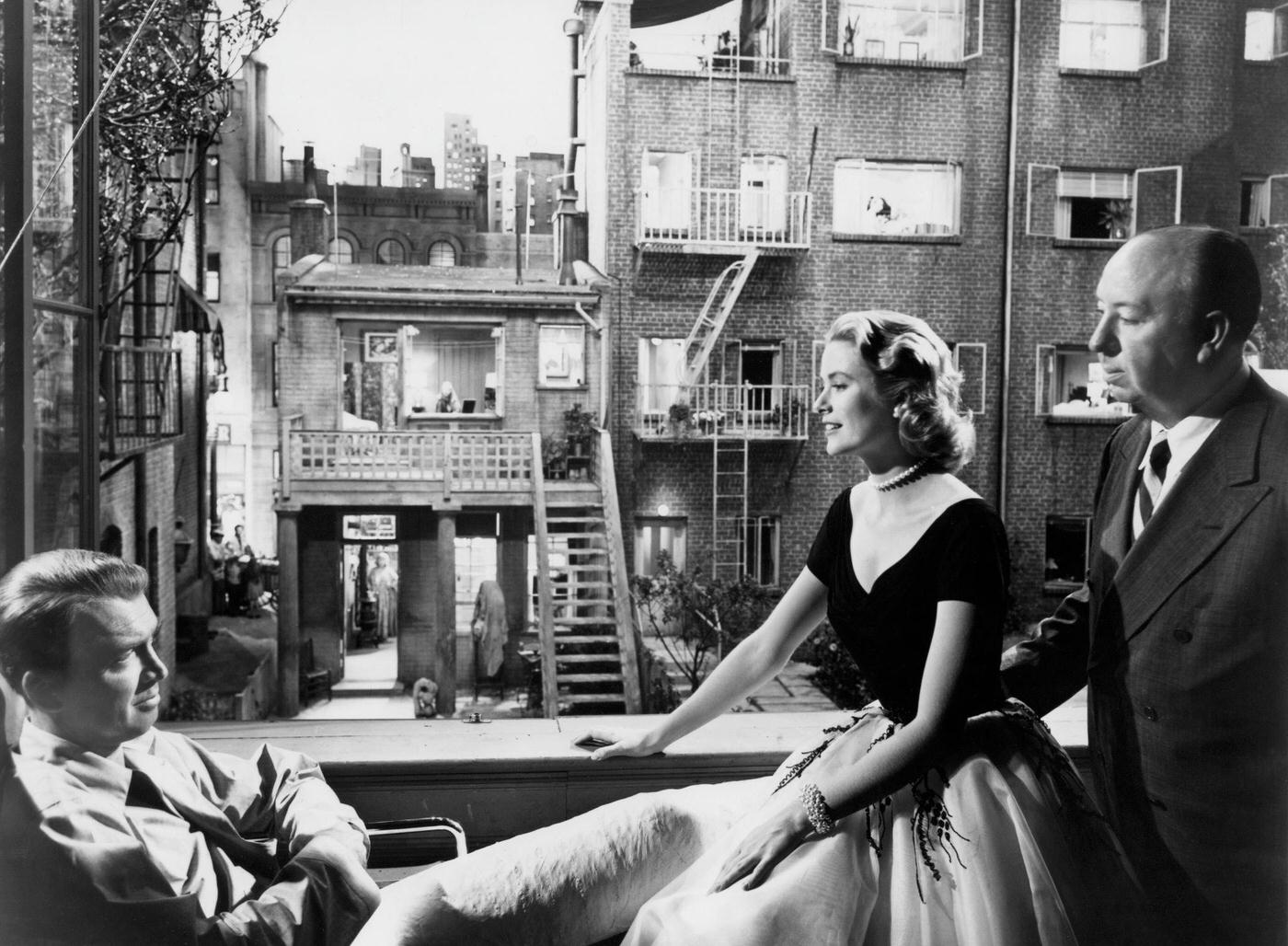 Grace Kelly and James Stewart with Alfred Hitchcock on the set of Rear Window.