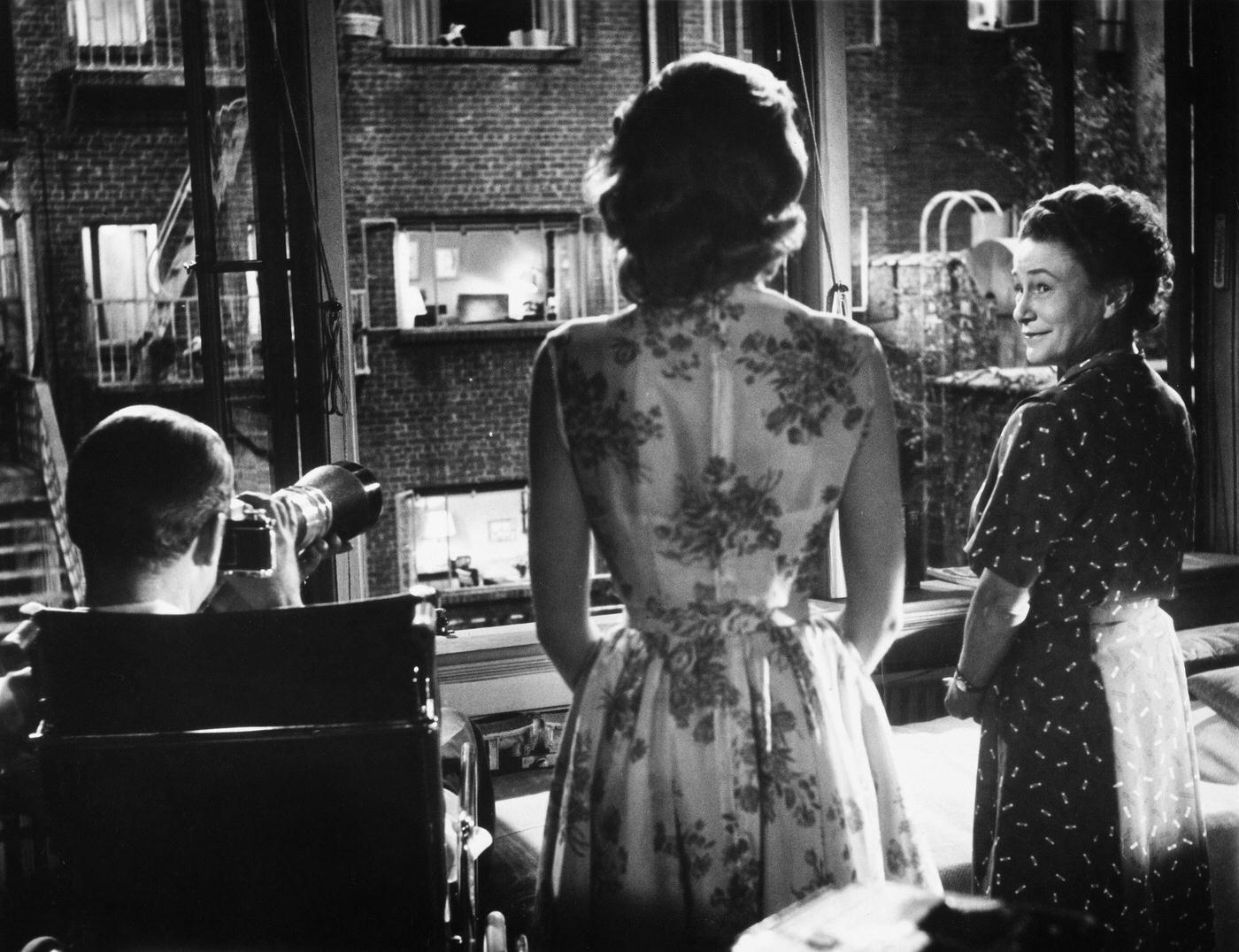 L.B. Jeffries (James Stewart), Lisa Carol Fremont (Grace Kelly), and Stella (Thelma Ritter) in a scene from the 1954 Rear Window.