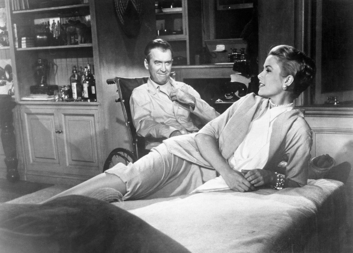 L.B. Jeffries (James Stewart) and Lisa Carol Fremont (Grace Kelly) chat in a scene from, Rear Window.