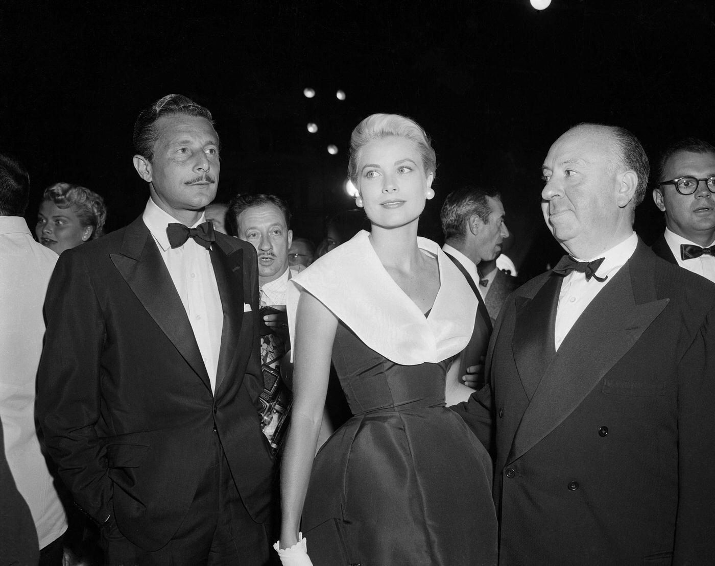 Alfred Hitchcock, Grace Kelly and Oleg Cassini at the premiere of "Rear Window."