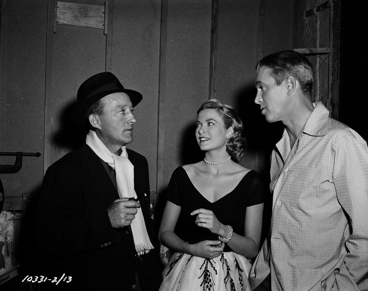 Bing Crosby visiting actors Grace Kelly and James Stewart on the set of their film 'Rear Window', 1954.