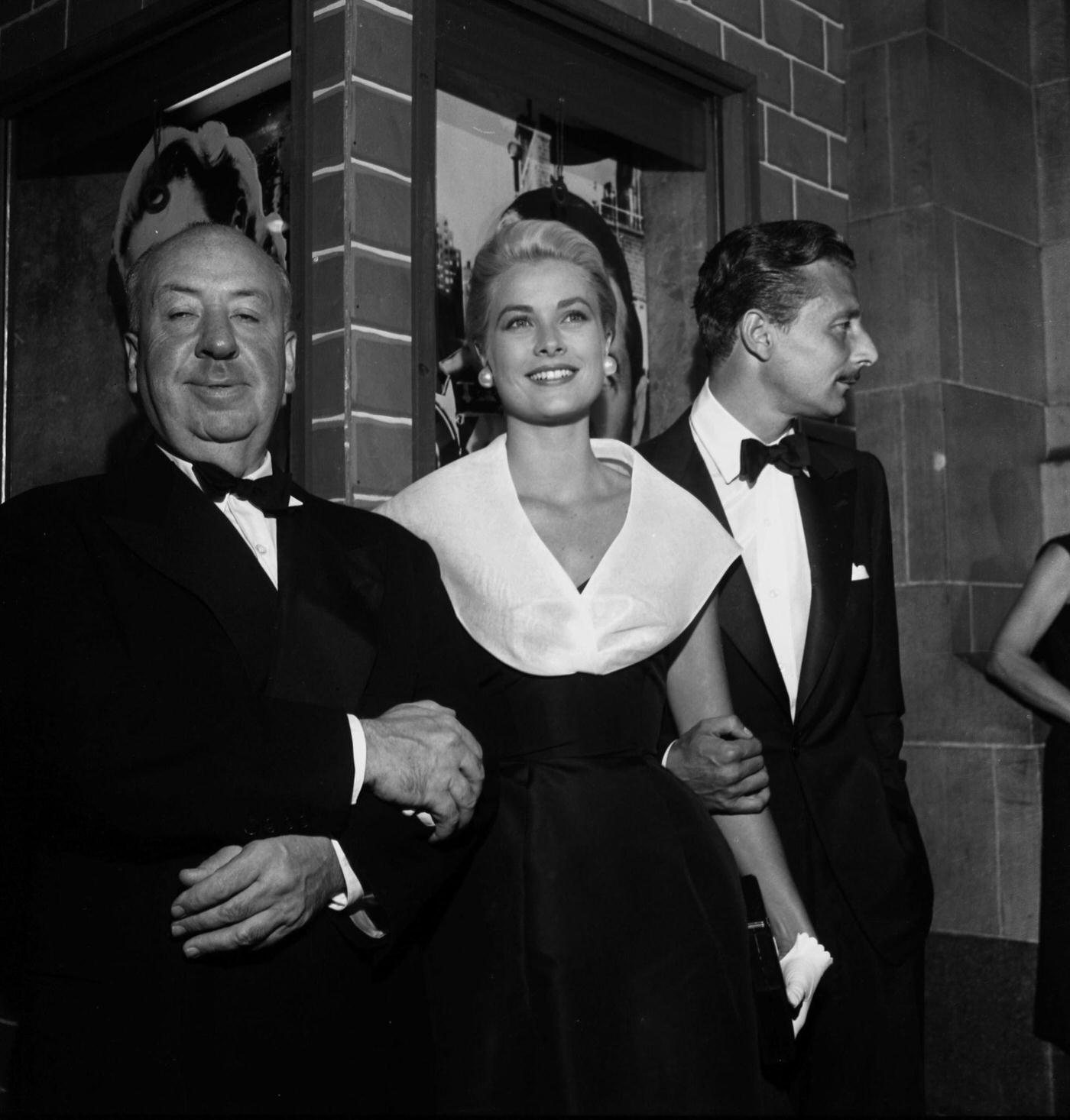 Director Alfred Hitchcock with actress Grace Kelly and Oleg Cassini at the premier of "Rear Window" in Los Angeles, California.