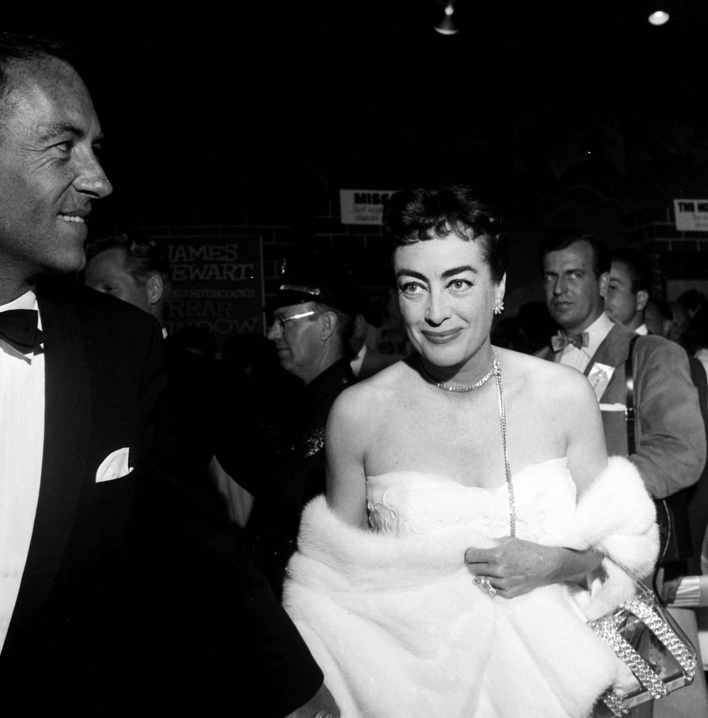 Joan Crawford attend a premiere "Rear Window" in Los Angeles