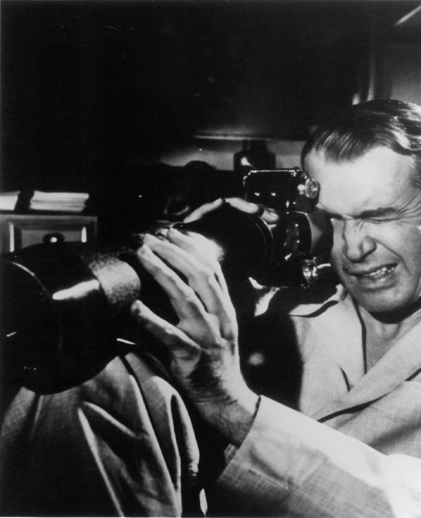 James Stewart looking through a scope in a scene from the film 'Rear Window', 1954.