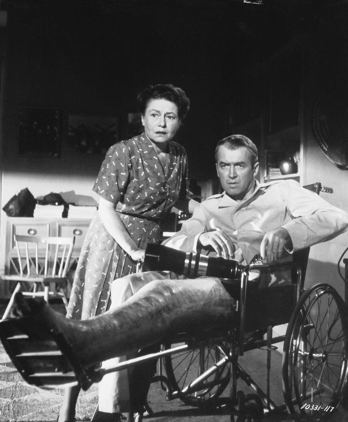 Wheelchair bound James Stewart with his nurse Thelma Ritter in a scene from Alfred Hitchcock's 'Rear Window'