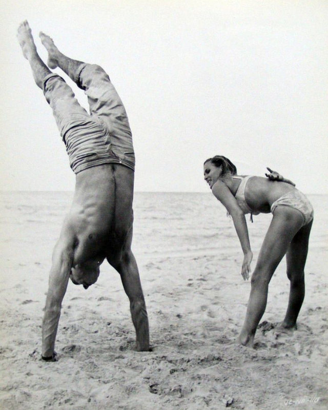 A Hands-On Lesson: Sean Connery Helps Ursula Andress Perfect a Handstand