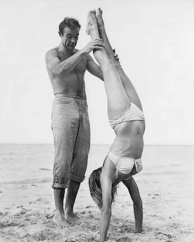 A Hands-On Lesson: Sean Connery Helps Ursula Andress Perfect a Handstand