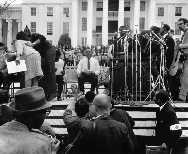 Martin Luther King Jr waiting to be introduced at the Alabama Capitol after leading the 54-mile march from Selma to Montgomery, 1965.