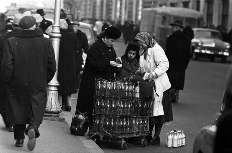 Mother and son buying milk from a vendor.