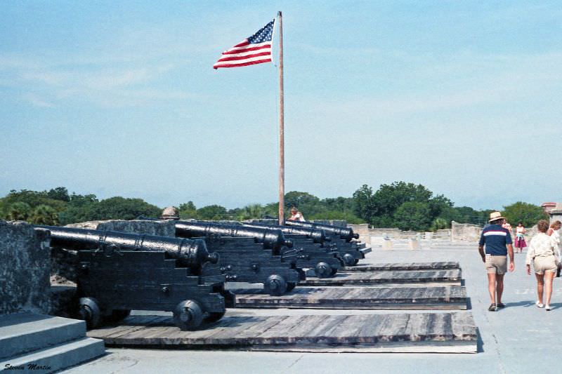 Row of cannons and U.S. flag flying over the fort, Castillo de San Marcos, St. Augustine, 1986