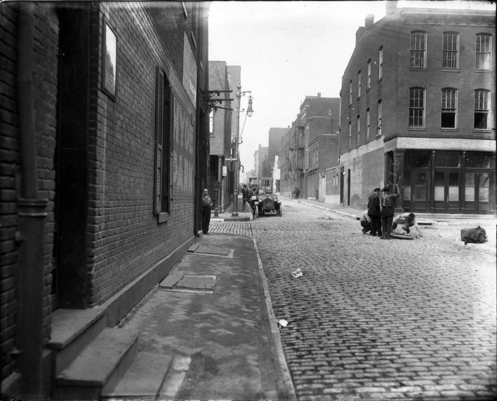 The intersection of Second Street with another street with men working in the middle of the intersection, 1900