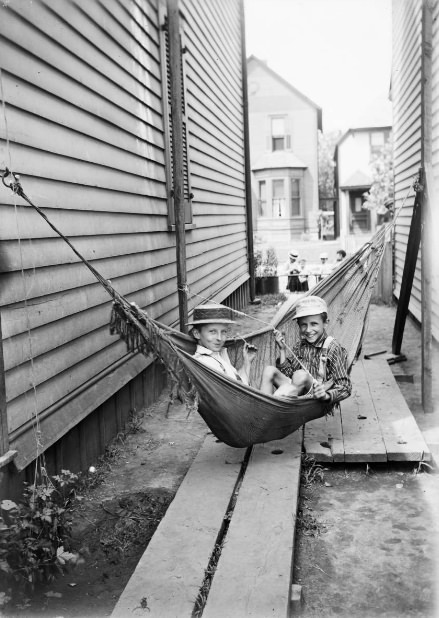 Buck and Bab in side yard swing, 1902