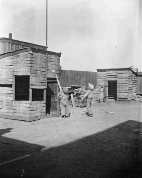 Children and chicken coop, 1900