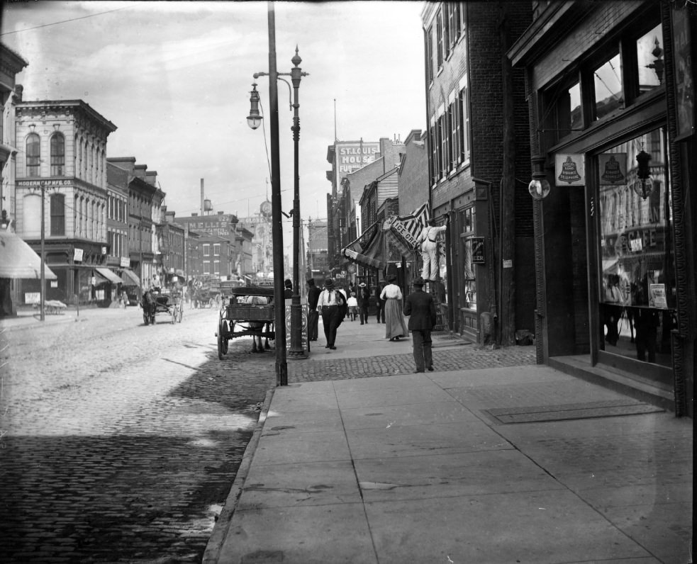 North 7th Street showing people at work and walking along street, 1900