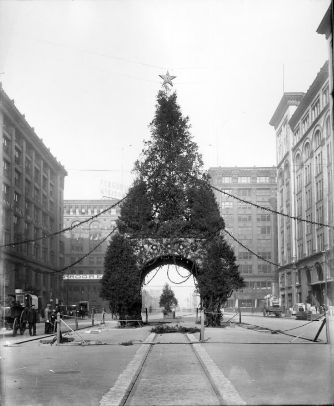 A Christmas Tree arch display being set up on North Tucker Boulevard, 1900