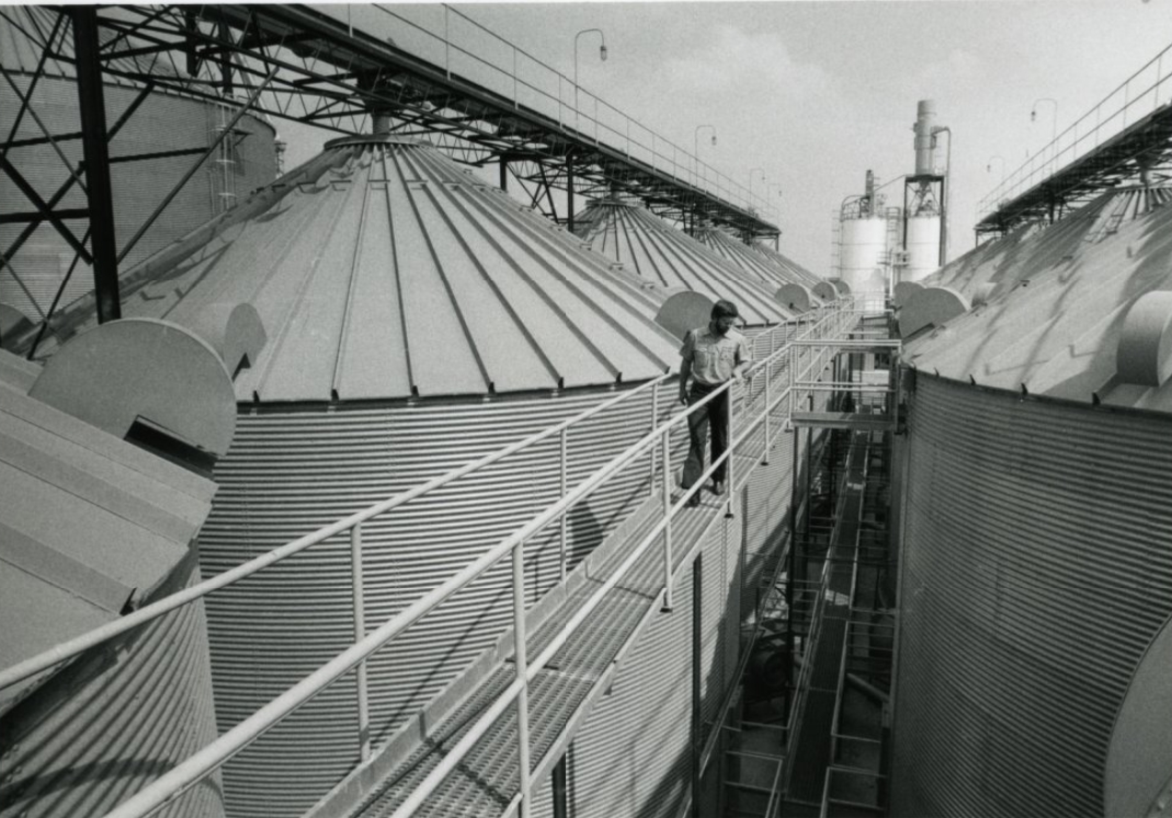 A worker inspects the Jonesboro, Arks, rice mill of Busch Agricultural Resources Inc, 1984