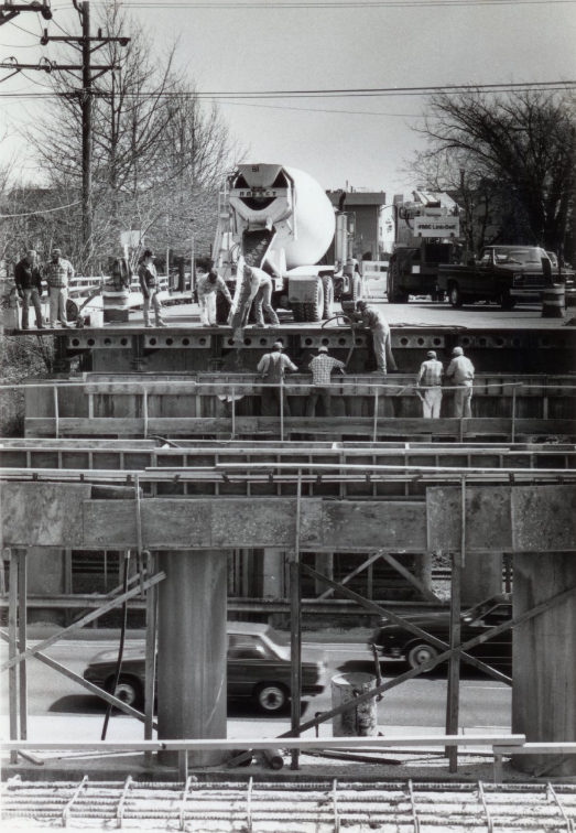 Concrete is poured on a form to bridge I-70 at Old Bonhommme, 1986