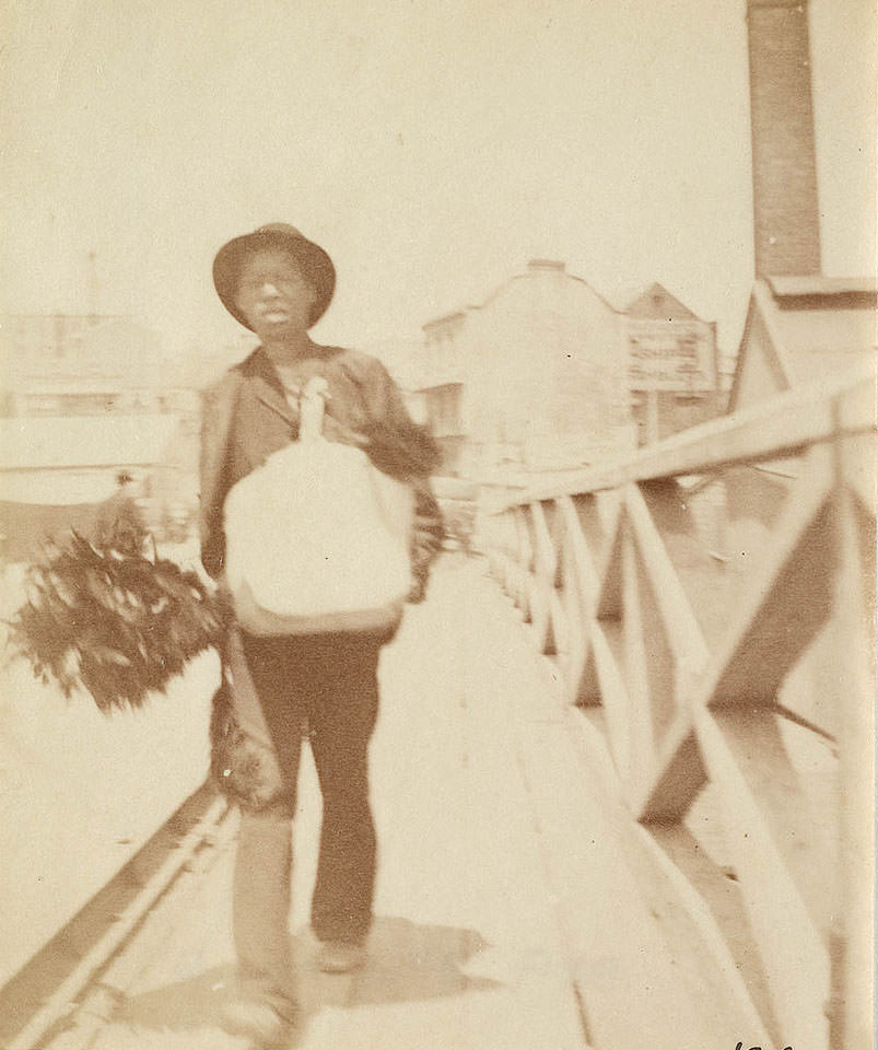 A chimney sweep walking across Pyrmont Bridge Sydney, 1888