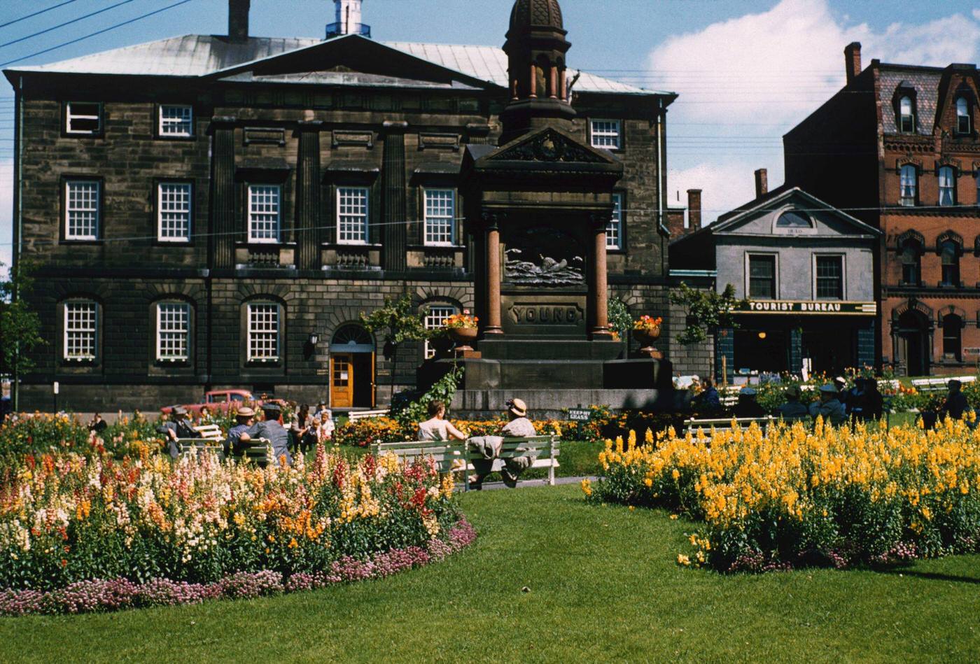The Young Memorial in King's Square, Saint John, New Brunswick, Canada, with the tourist bureau (later the Old No.2 Engine House Museum) on Sydney Street in the background right, 1960.