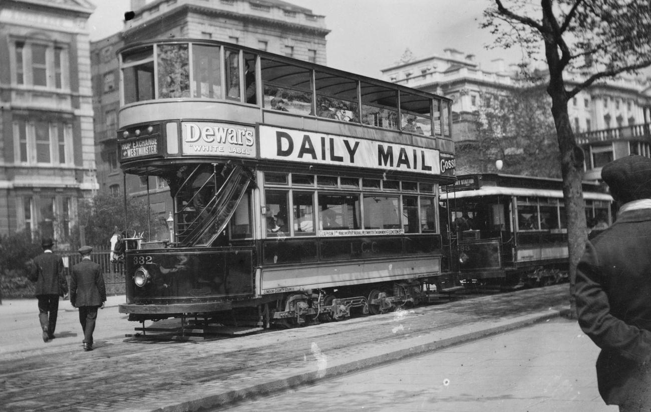 Double Decker London Tram Car has signs advertising Dewar's Whiskey & the Daily Mail Newspaper